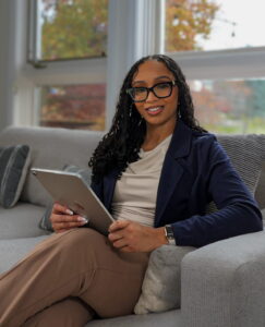 Jessica, Founder of Imperative Concierge Services, using a tablet to manage virtual support systems for growing businesses.