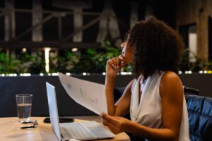 Business leader evaluating strategy vs instructions virtual assistant delegation approach while reviewing documents