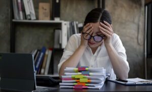 Overwhelmed business owner stressed by full-time virtual assistant management burden