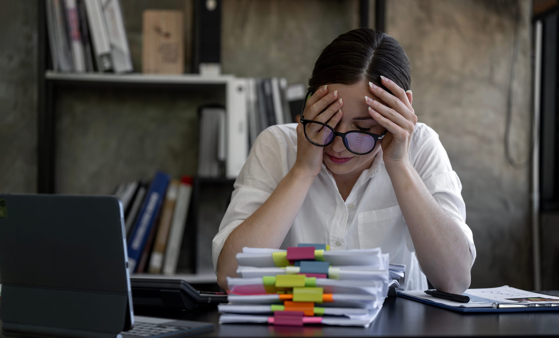 Overwhelmed business owner stressed by full-time virtual assistant management burden