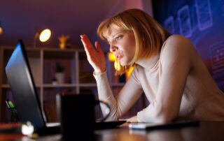 Frustrated businesswoman working late at computer dealing with generalist virtual assistant support issues