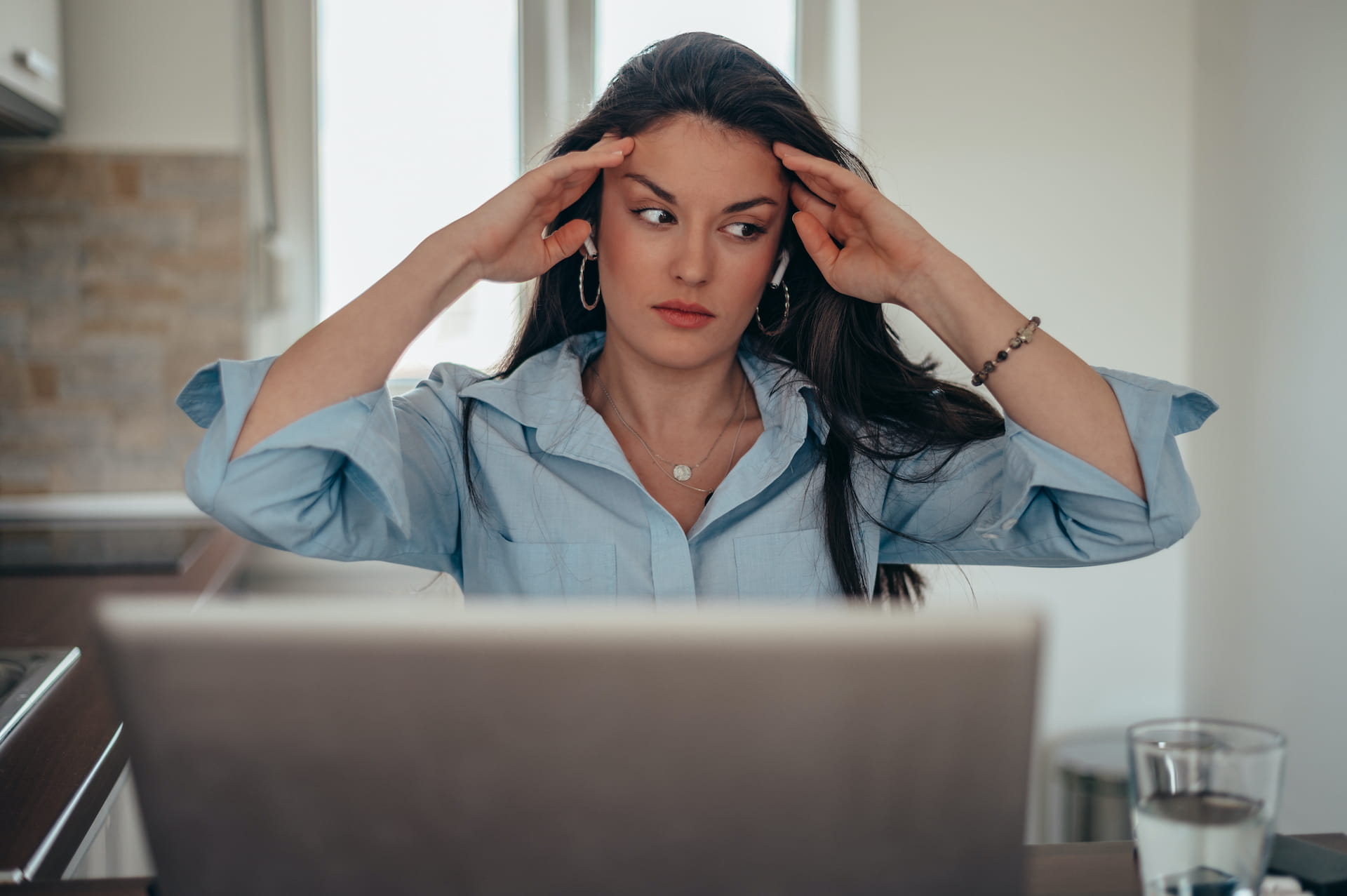 Frustrated business professional at laptop realizing her dedicated virtual assistant model isn't working