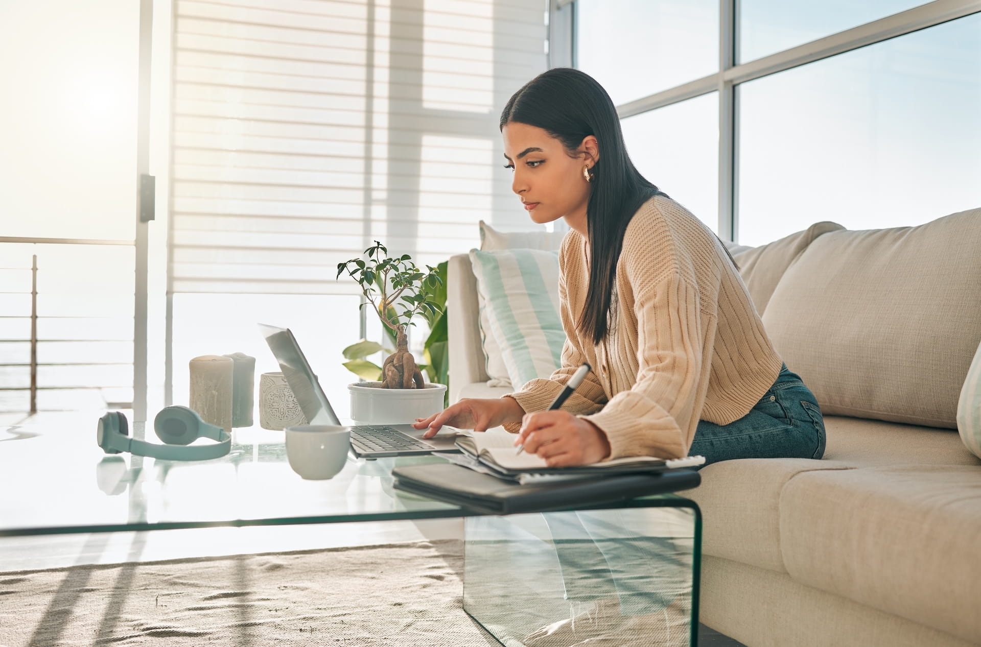 Professional accessing weekend virtual support while working from home office with laptop and planning materials