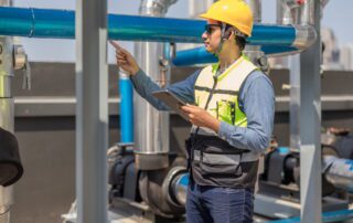 Technician reviewing operations on tablet at job site