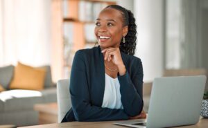 Professional coach at laptop preparing to hire virtual assistant for coaching business